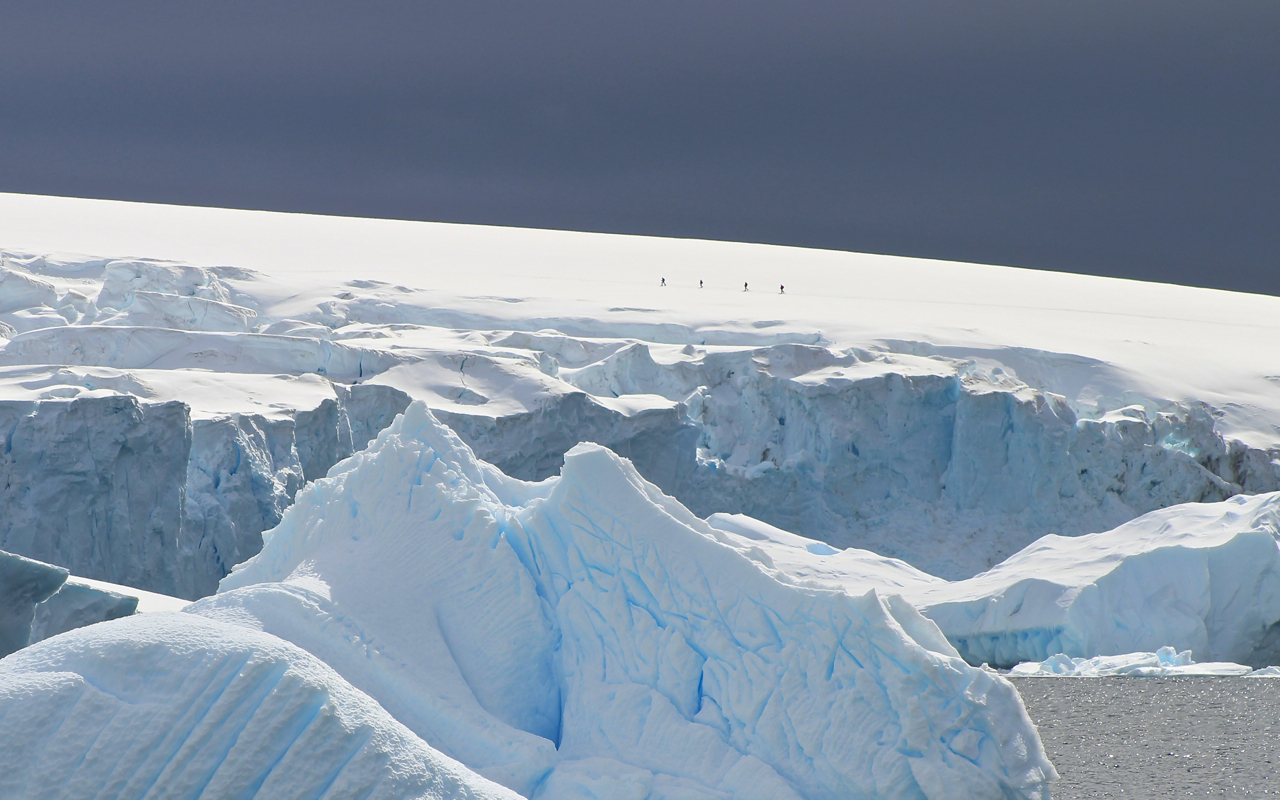 Snowshoers enjoy an exclusive vantage point from high atop a ridge on the Antarctic Peninsula. Photo: Miranda Miller