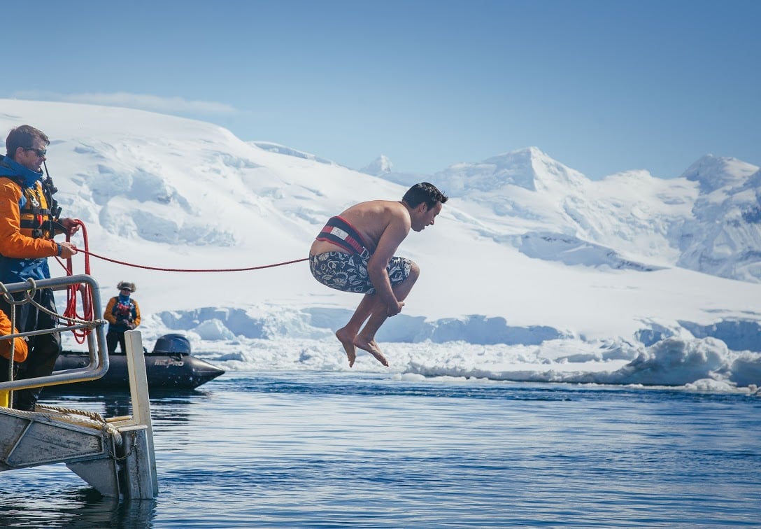 Passenger Craig Shaw takes the plunge, cannonballing into frigid Antarctic waters. Photo: Amanda Wells