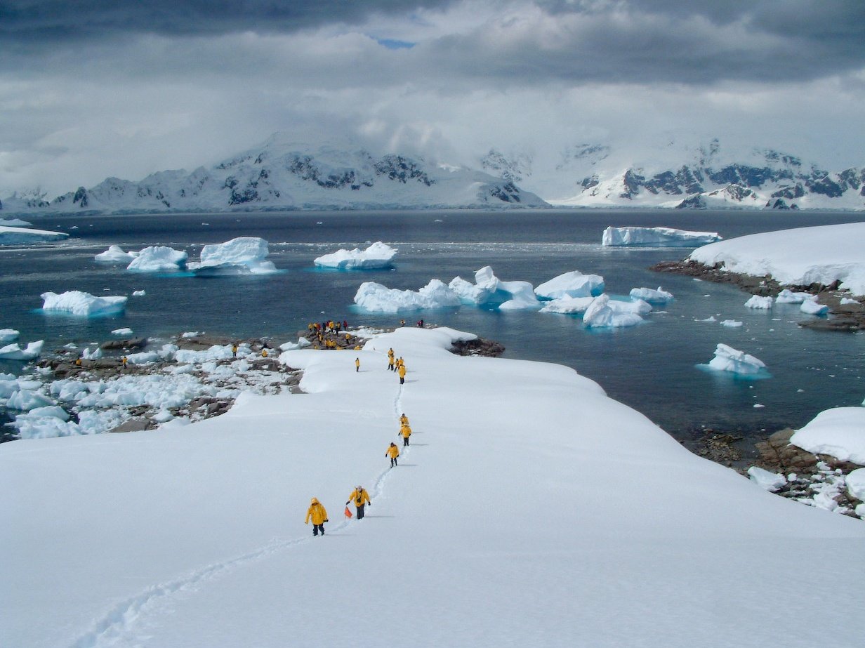 Passengers hike the rugged Antarctic Peninsula on a shore landing.