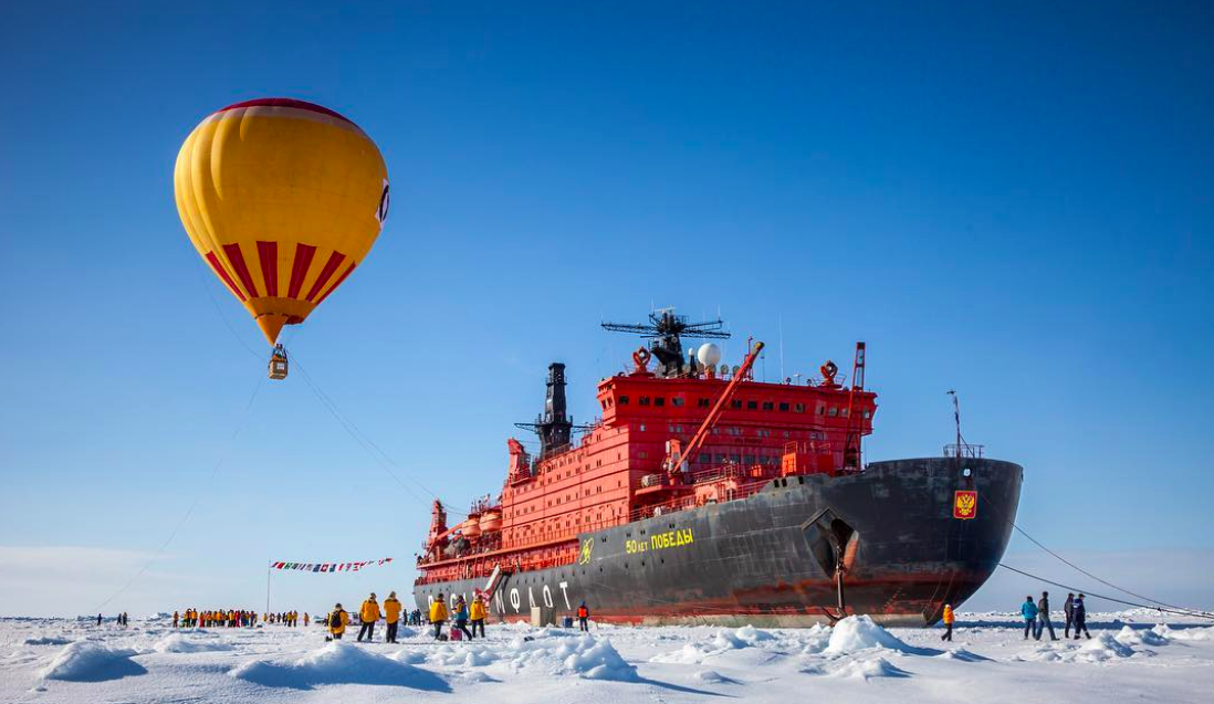 Passengers celebrate reaching 90 degrees North with an optional hot air balloon ride over the ice.