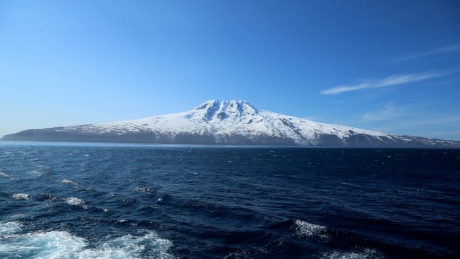 Mysterious, uninhabited Jan Mayen rises out of the deep, frigid blue of the Norwegian Sea.